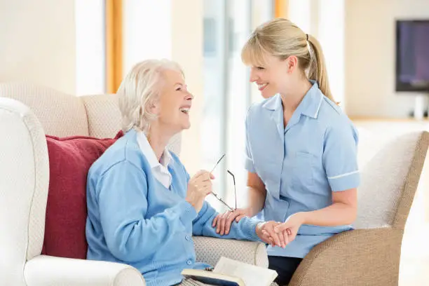 Photo of Caregiver talking with older woman