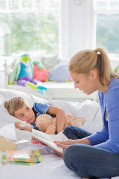 istock Mother reading to son in bed 166272540