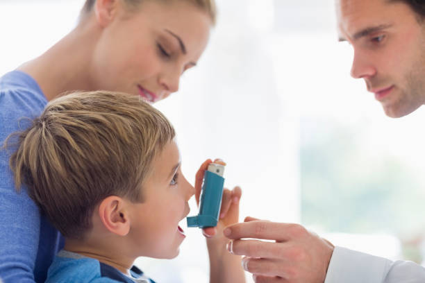 istock Parents giving son asthma inhaler 166272559