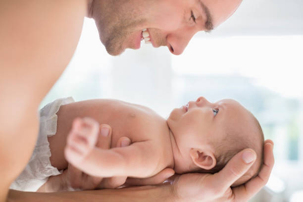 istock Father cradling newborn baby 166272584