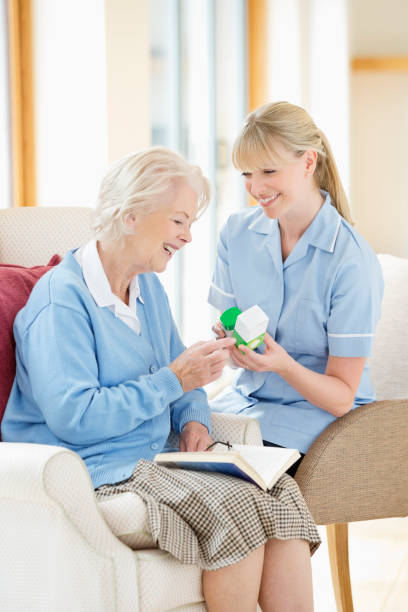istock Caregiver talking with older woman 166272606