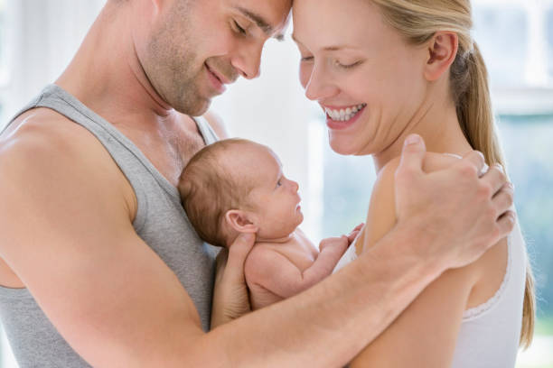 istock Parents cradling newborn baby 166272607