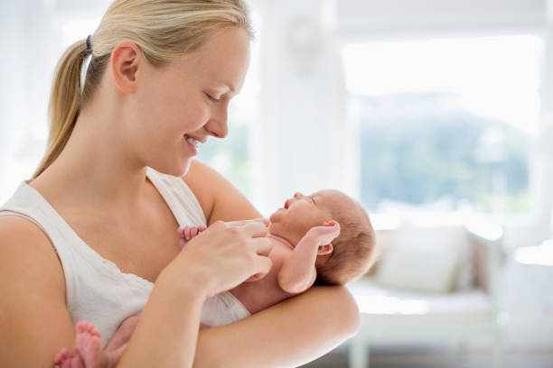 istock Mother cradling newborn baby 166272635