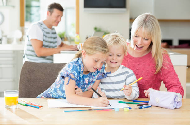 istock Mother and children coloring at table 166272694