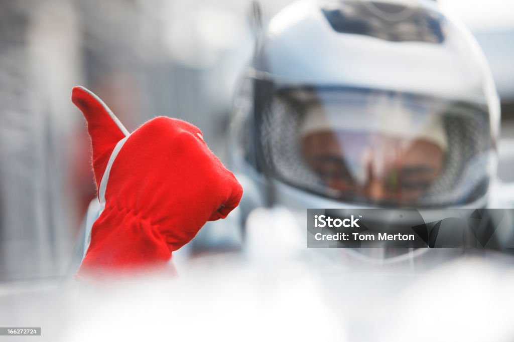 Racer giving thumbs up in car  Auto Racing Stock Photo