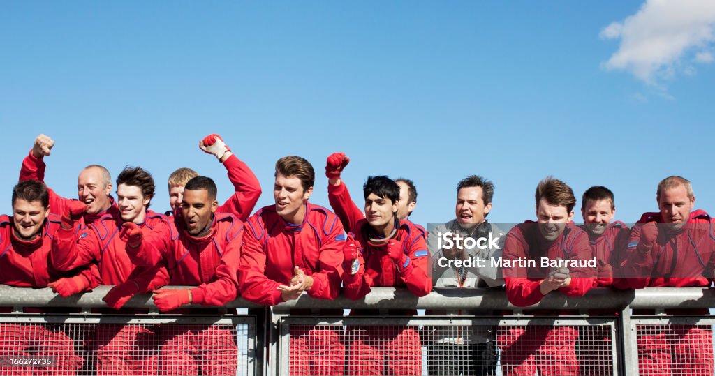 Racing team cheering on sidelines  Sports Team Stock Photo