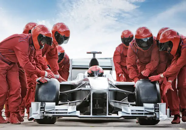 Photo of Racing team working at pit stop