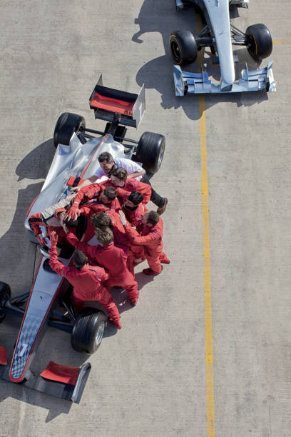 istock Race team surrounding racer on track 166272772