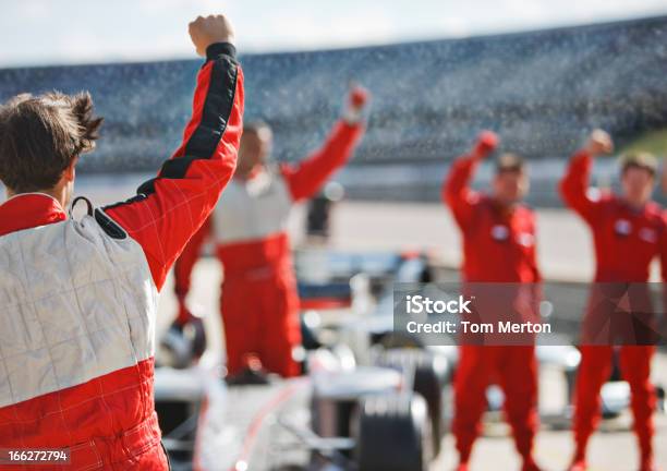 Racer And Team Cheering On Track Stock Photo - Download Image Now - Racecar, Sports Race, Auto Racing