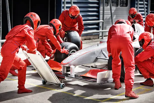 Photo of Racing team working at pit stop