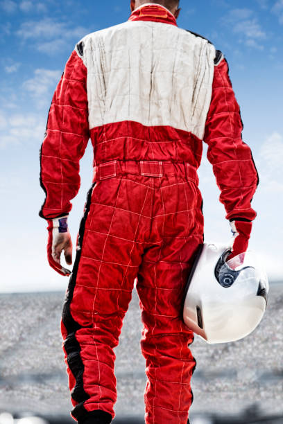 istock Racer carrying helmet on track 166272802