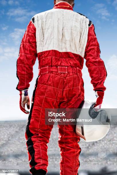 Racer Carrying Helmet On Track Stock Photo - Download Image Now - Auto Racing, Fan - Enthusiast, Sports Race