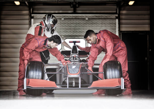 Racing team working in garage  pitstop stock pictures, royalty-free photos & images