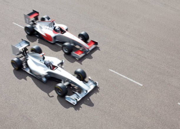 istock Race cars driving on track 166272867
