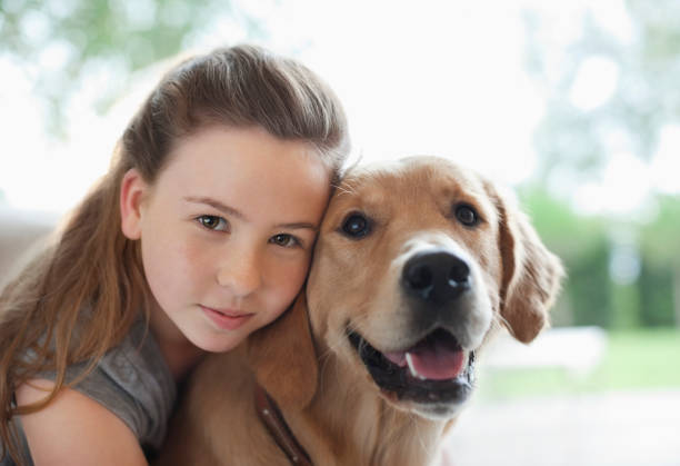 istock Girl hugging dog indoors 166272937