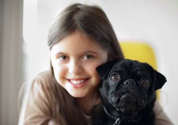 istock Smiling girl holding dog 166273031