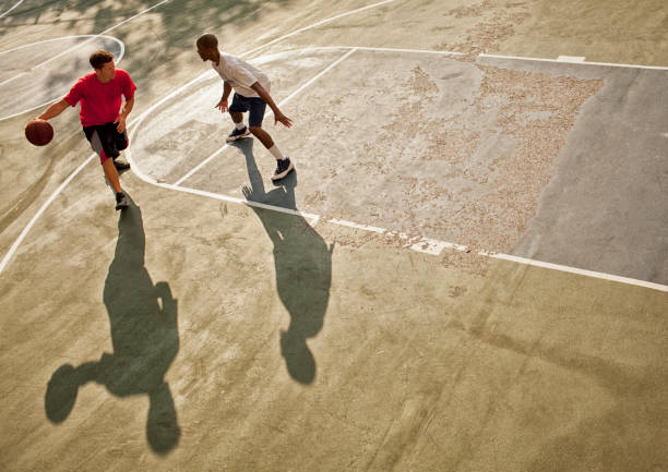 istock Men playing basketball on court 166273659