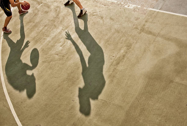 istock Men playing basketball on court 166273669