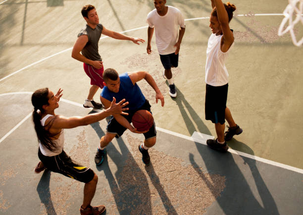 Men playing basketball on court  defending sport stock pictures, royalty-free photos & images