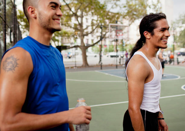 Men laughing on basketball court  american indian stock pictures, royalty-free photos & images