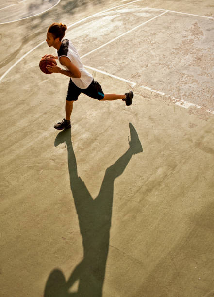 istock Man playing basketball on court 166273764