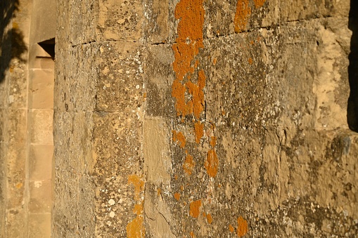A closeup of a rusty stain on a stone wall of an old church