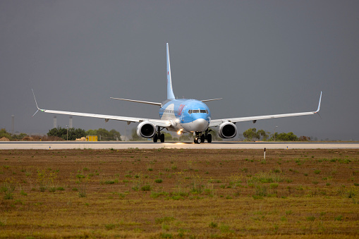 Luqa, Malta - August 31, 2023: TUI Airways Boeing 737-8K5 (REG: G-TAWL) taking off after a shower.