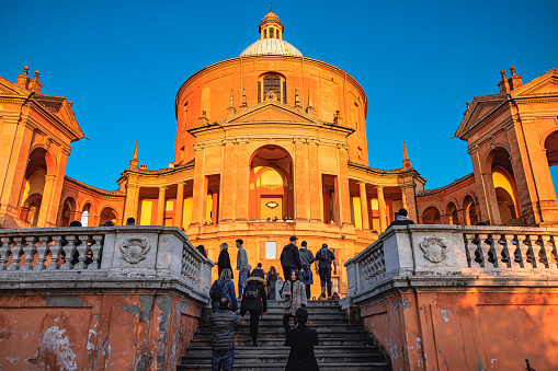 Bologna, Italy - March 05, 2023: People going up the staircase to the Sanctuary of the Blessed Virgin of Saint Luke, also known as 666 Porticos in Bologna, Italy