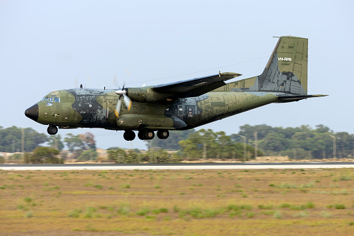 A Lockheed C-130 Hercules of the Royal Netherlands Air Force parked on a platform at the Dutch Air Force Base Eindhoven. The C-130 has a special tail decoration celebrating 25 years of service.