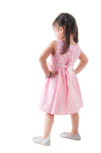Full body rear view Asian girl in pink dress standing on white background