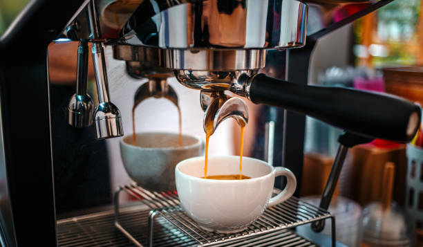 istock Coffee extraction from the coffee machine with a portafilter pouring coffee into a cup,Espresso pouring from the coffee machine at coffee shop 1662850977