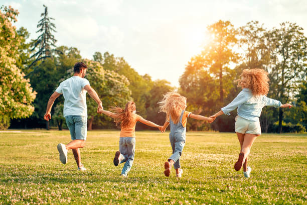 istock Happy family relaxing in the park 1662851596