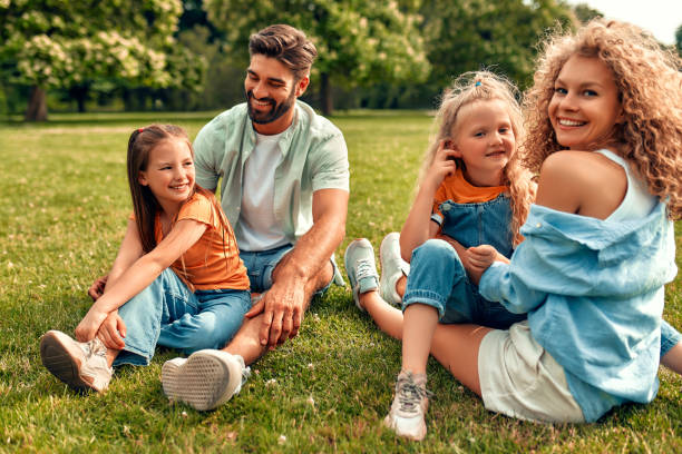 istock Happy family relaxing in the park 1662852659