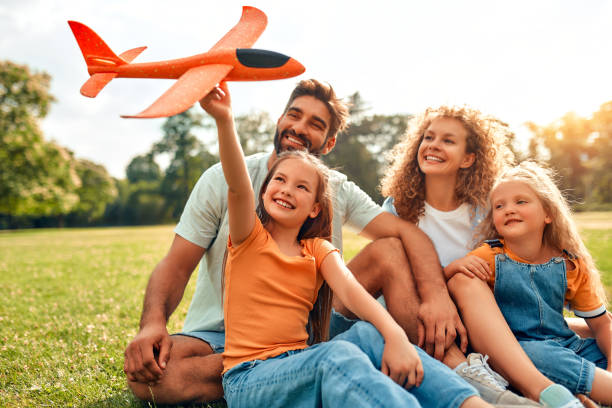 istock Happy family relaxing in the park 1662852970