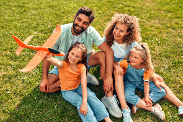 istock Happy family relaxing in the park 1662853313