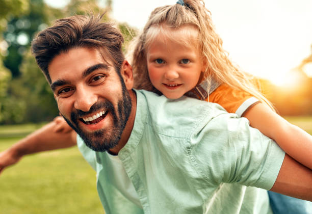 istock Happy family relaxing in the park 1662853390