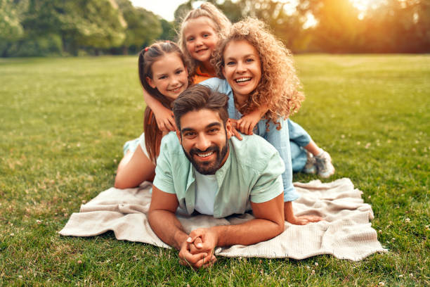 istock Happy family relaxing in the park 1662853399