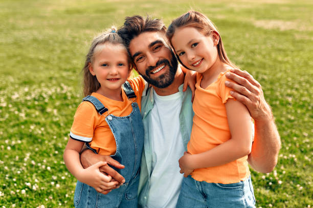 istock Happy family relaxing in the park 1662855111