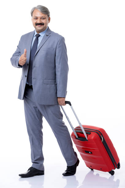 Businessman with suitcase gesturing thumbs up sign on white background