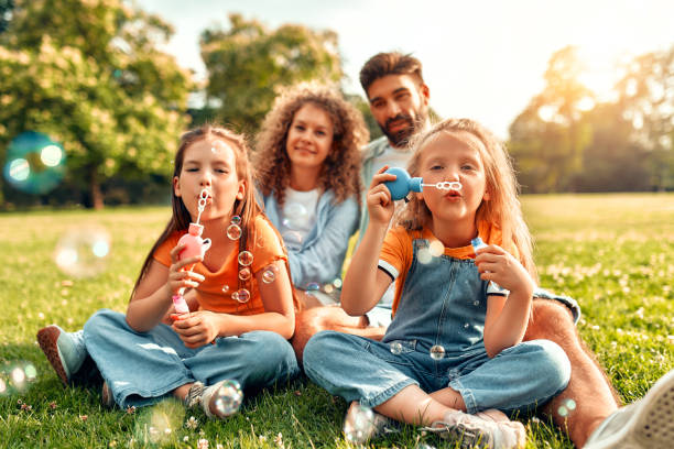 istock Happy family relaxing in the park 1662856661