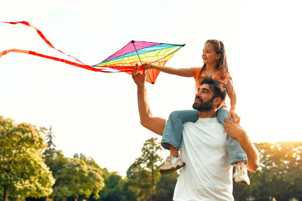 istock Happy family relaxing in the park 1662856682