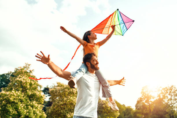 istock Happy family relaxing in the park 1662856685