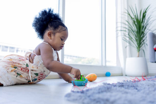 istock A cute black curly hair lying down on the floor playing plastics toy.Imaginative Play. 1662863372
