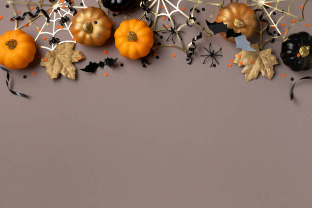 istock Halloween party decorations frame from pumpkins, bats, spider web and ghosts top view. Happy halloween holiday greeting card concept. 1662872659