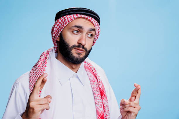 istock Arab man crossing fingers for good luck 1662876593