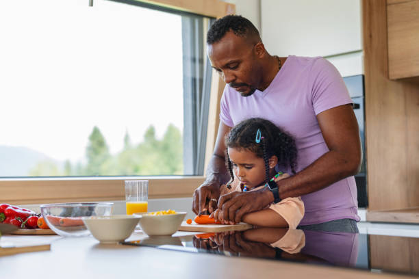 istock Supportive Black Father Teaching His Young Daughter How To Cook 1662885067