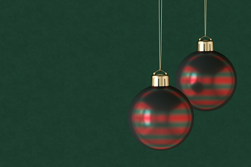 Christmas ornaments on green color background, new year concept. Digitally generated image.