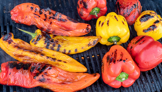 preparing red and yellow bell pepper on the barbecue bbq grill.