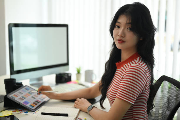 istock Creative woman using digital tablet and working with choosing color samples on desk at graphic studio 1662908655