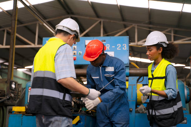 istock Blue collar workers work at machinery factory. 1662923369